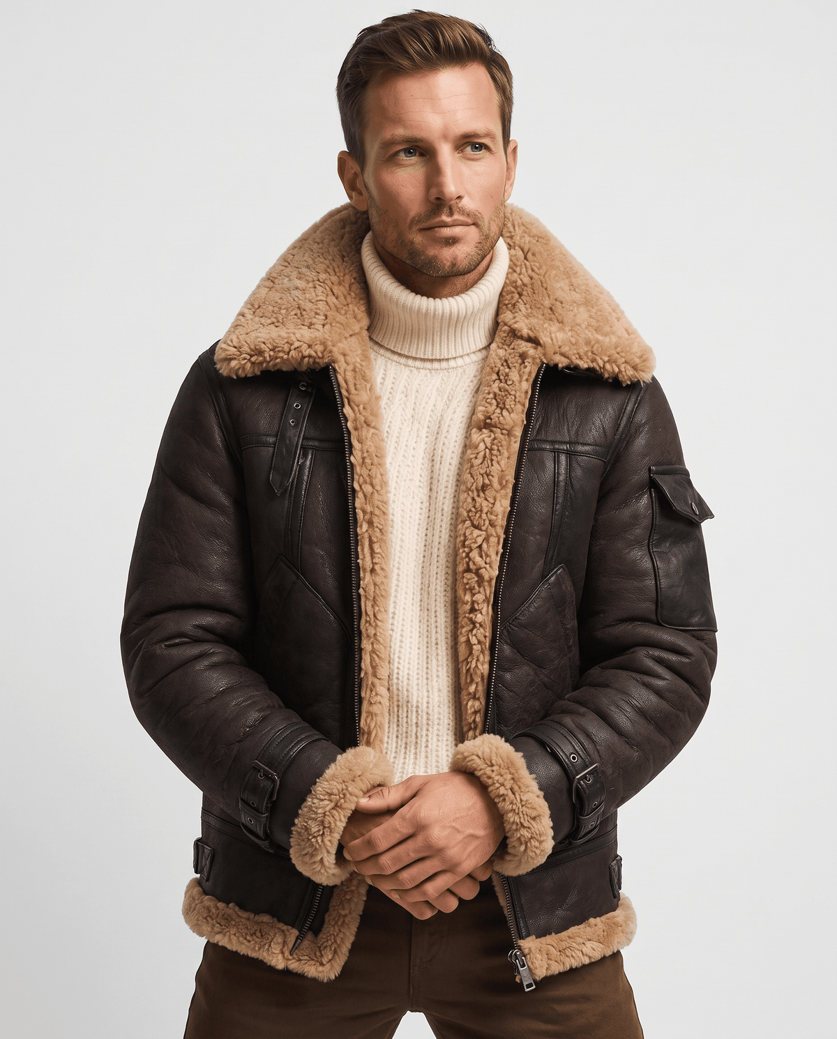 A man wearing a brown leather shearling jacket with fur lining and utility pockets, front view