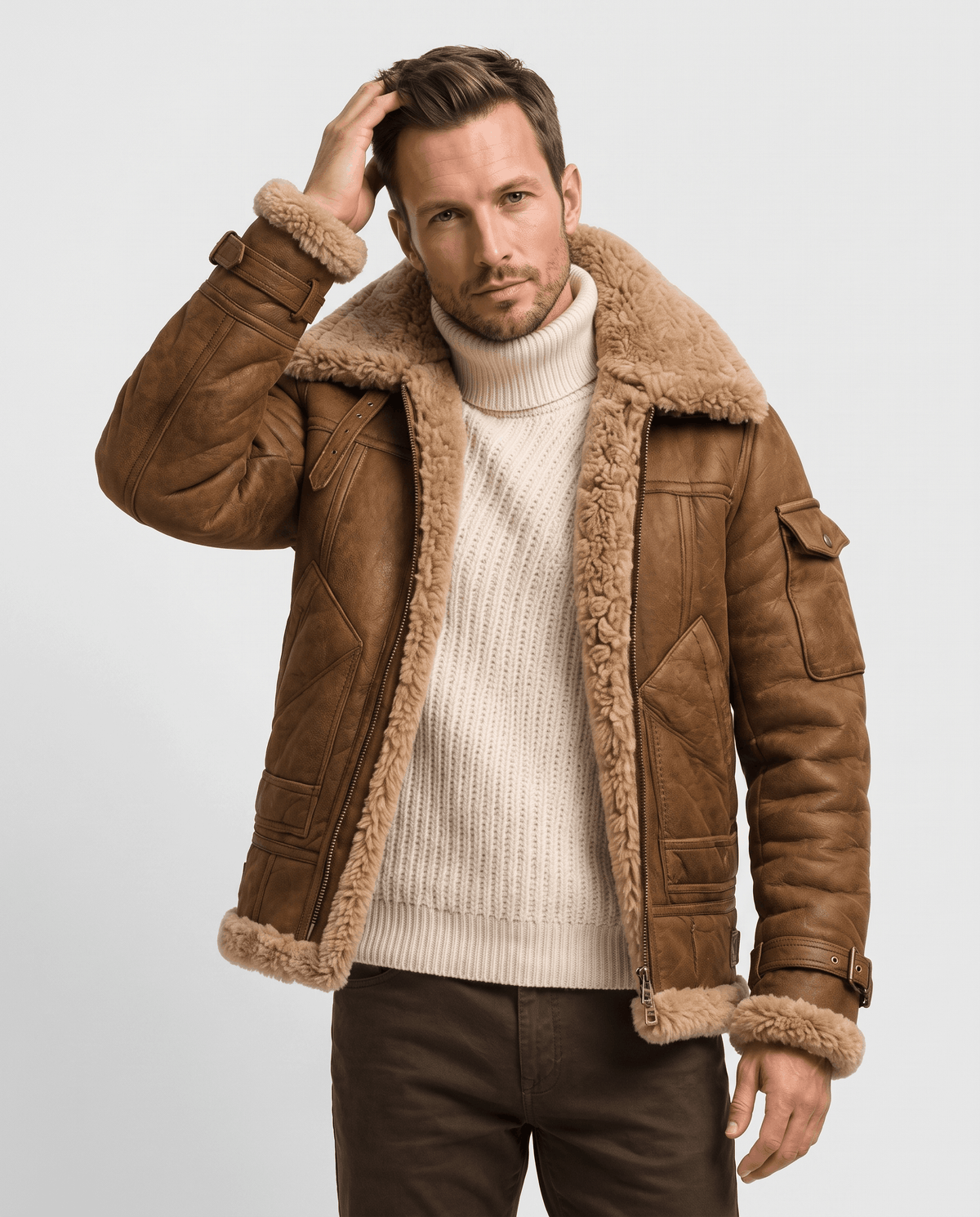 A man wearing a brown leather shearling jacket with fur lining and utility pockets