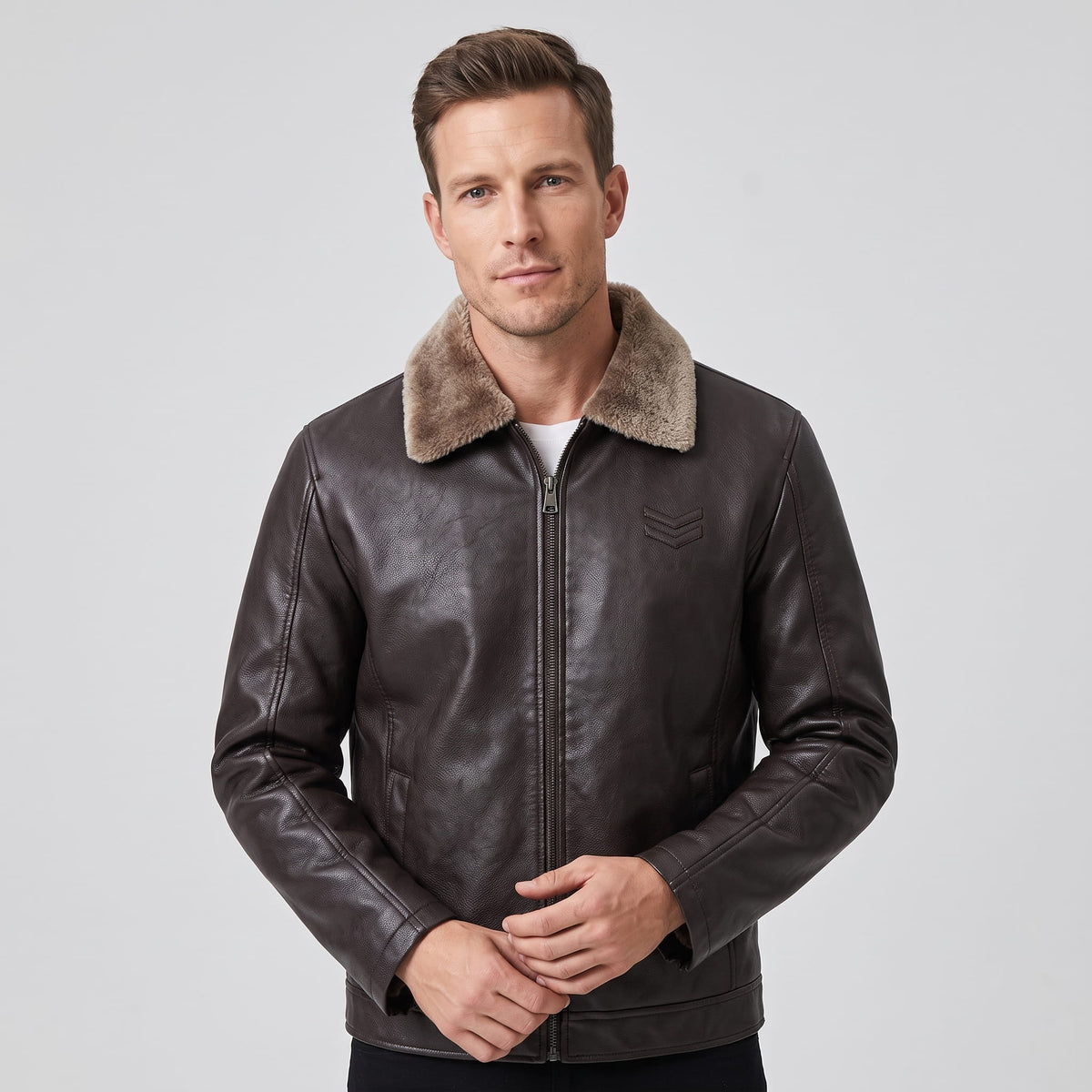 A man wearing a dark brown leather shearling jacket with a plush collar and full-zip front