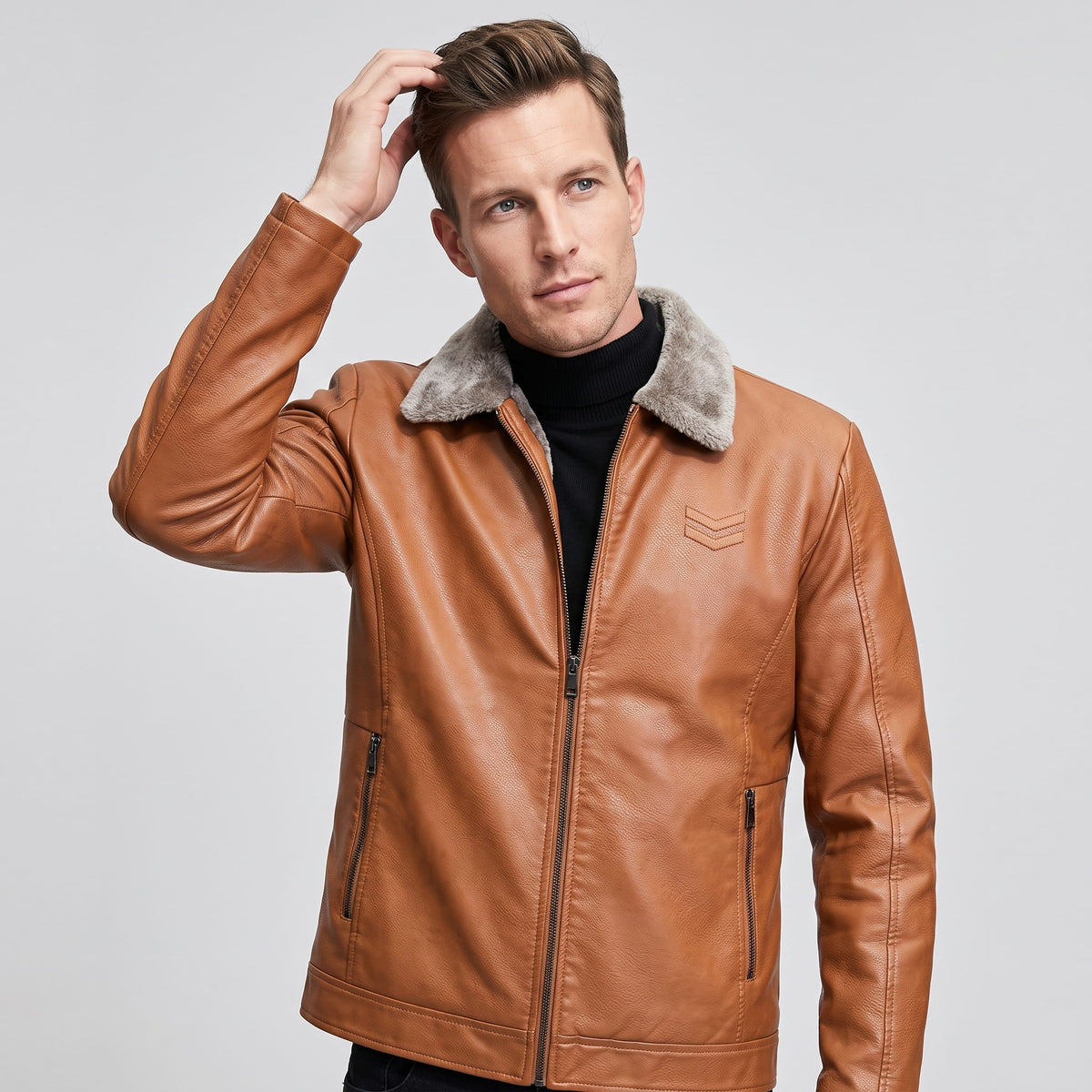 A man wearing a brown leather shearling jacket with a plush collar and full-zip front