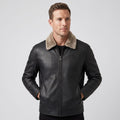 A man wearing a black leather shearling jacket with a plush collar and full-zip front