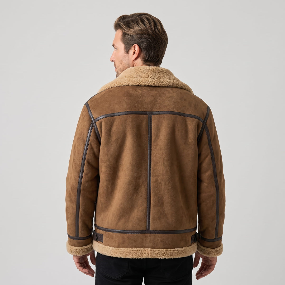 A man wearing a brown leather shearling jacket with sherpa lining and a notched collar, shown from the back