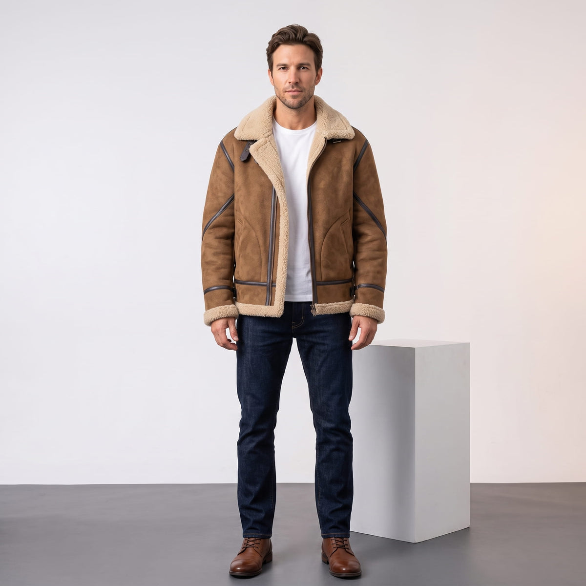 A man wearing a brown leather shearling jacket with sherpa lining and a notched collar, full-length view