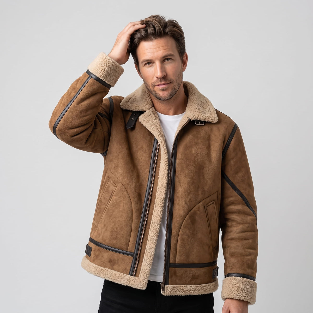 A man wearing a brown leather shearling jacket with sherpa lining and a notched collar