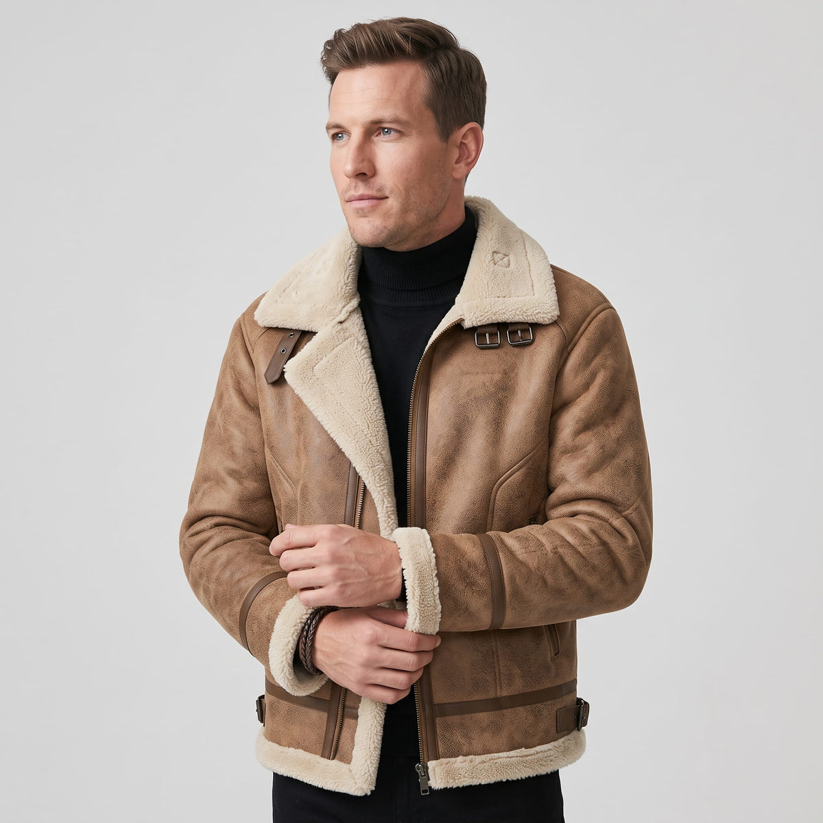 A man wearing a brown leather sherpa aviator jacket with fleece lining and zip pockets, front view