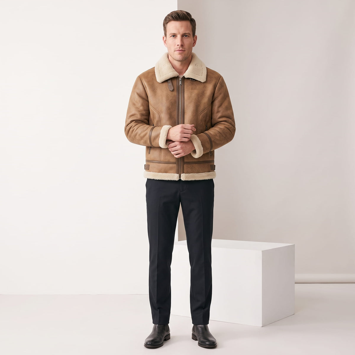 A man wearing a brown leather sherpa aviator jacket with fleece lining and zip pockets, full-length view