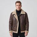 A man wearing a dark brown leather sherpa aviator jacket with fleece lining and zip pockets