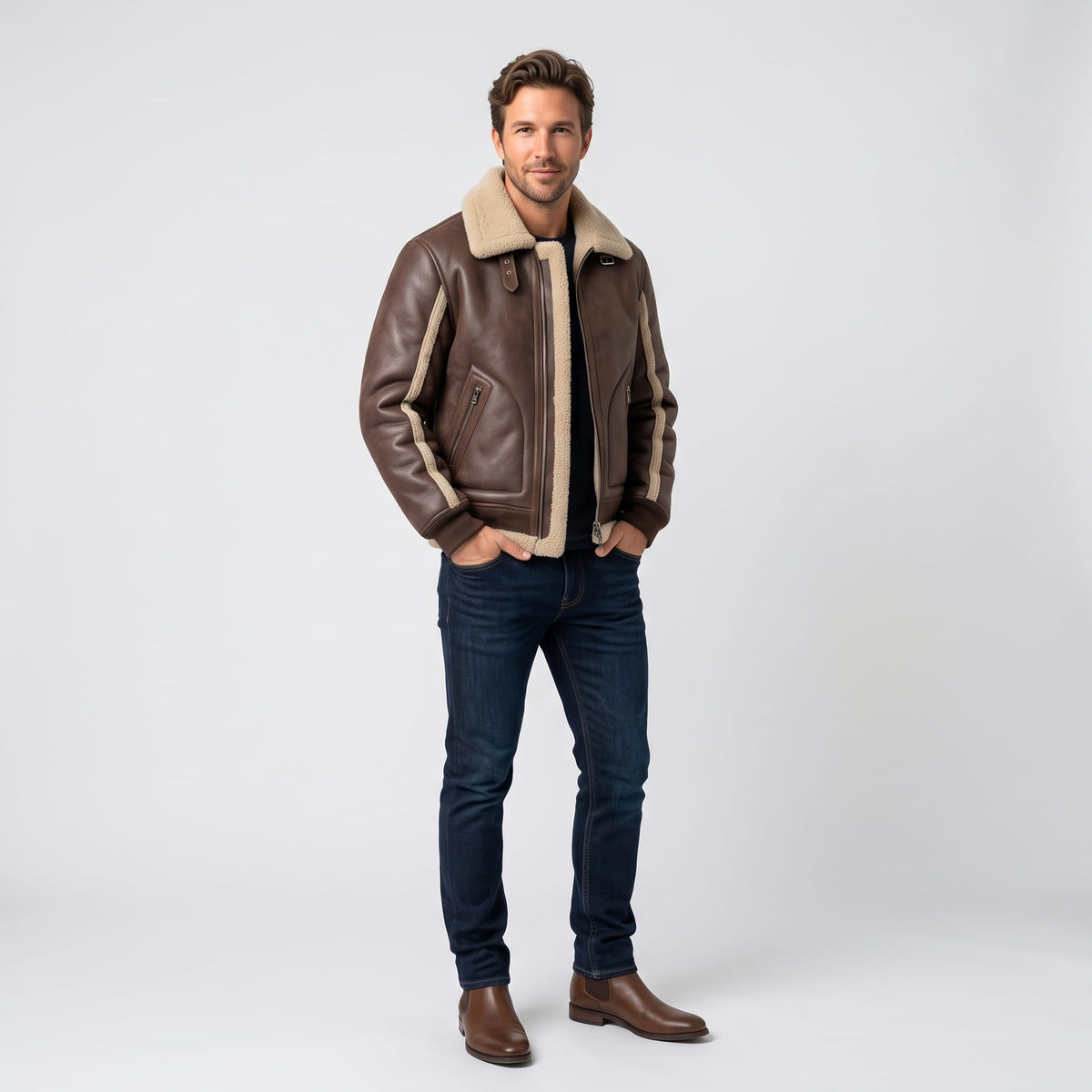 A man wearing a brown leather sherpa aviator jacket with a wide collar and ribbed trim, full-length view