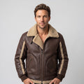 A man wearing a brown leather sherpa aviator jacket with a wide collar and ribbed trim