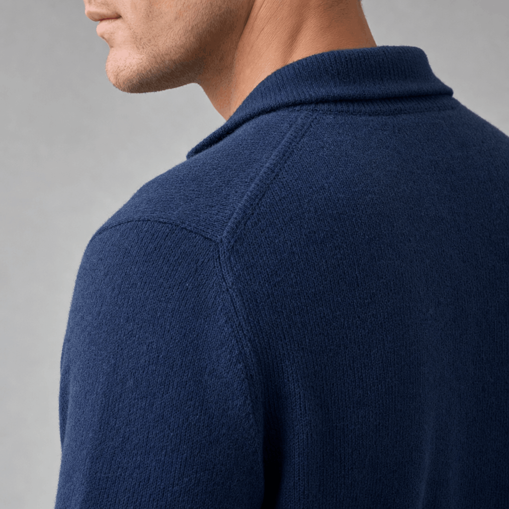 Side close-up showing the raised collar and textured knit of the navy blue sweater.