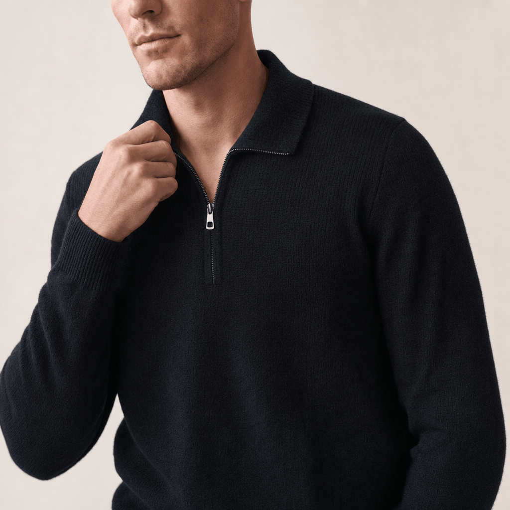 Close-up showing the half-zip neckline and textured knit detail of the black sweater.