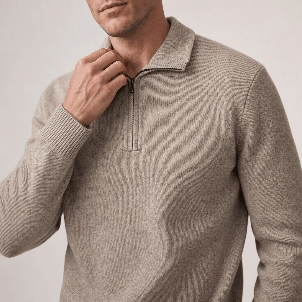 Close-up showing the half-zip neckline and textured knit of the light taupe sweater.