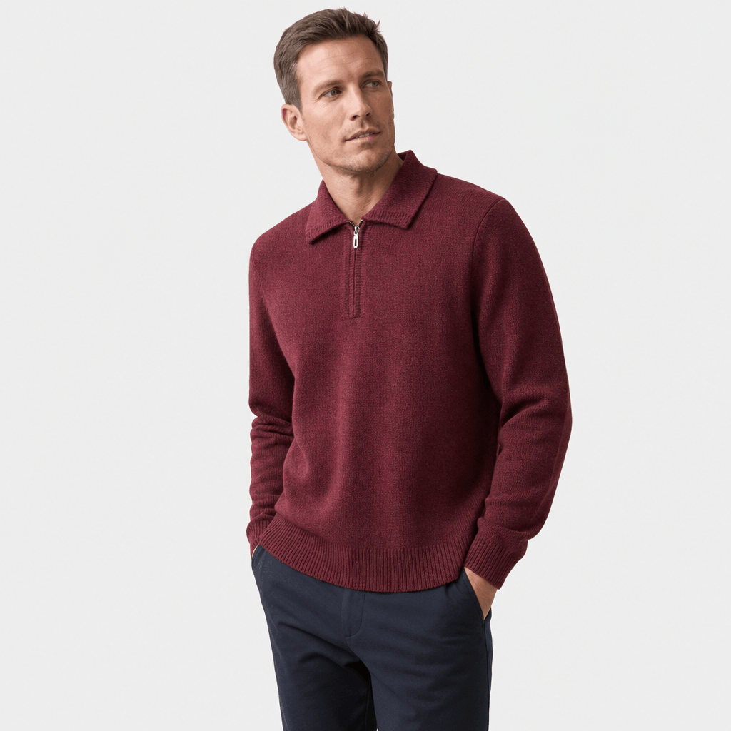 Man wearing a burgundy textured half-zip sweater with dark pants, shown in a relaxed standing pose.