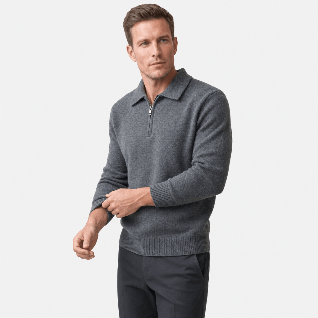 Man wearing a charcoal gray textured half-zip sweater with dark pants, shown in a relaxed standing pose.