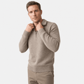 Man wearing a light taupe textured half-zip sweater with matching beige pants, shown adjusting the collar.
