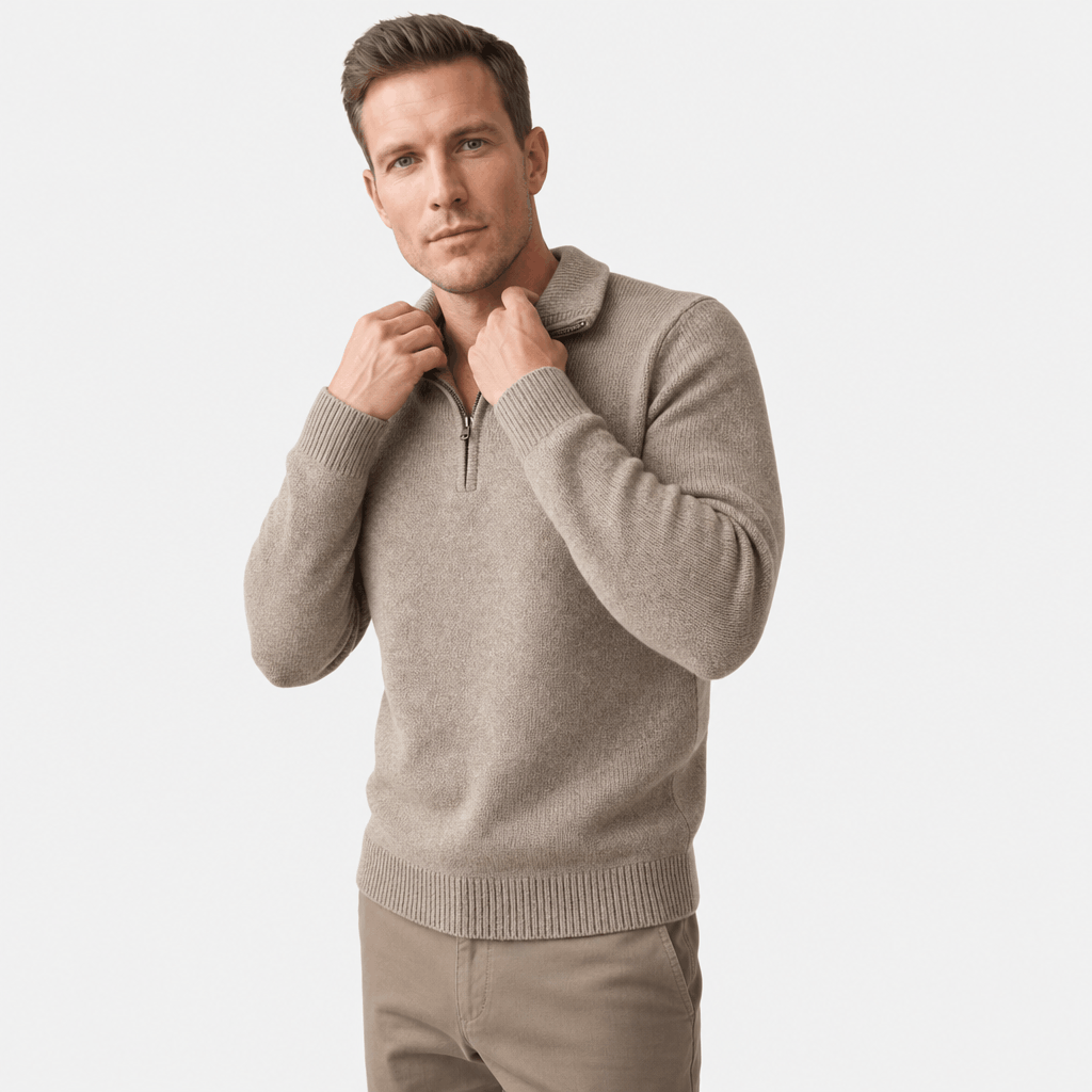 Man wearing a light taupe textured half-zip sweater with matching beige pants, shown adjusting the collar.