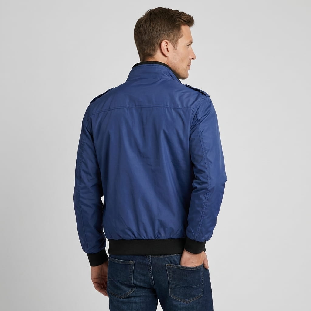 Back view of the man wearing the navy blue bomber jacket.