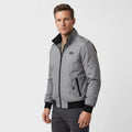 Man wearing a light gray zip-front bomber jacket with a black stand collar and black ribbed cuffs and hem.