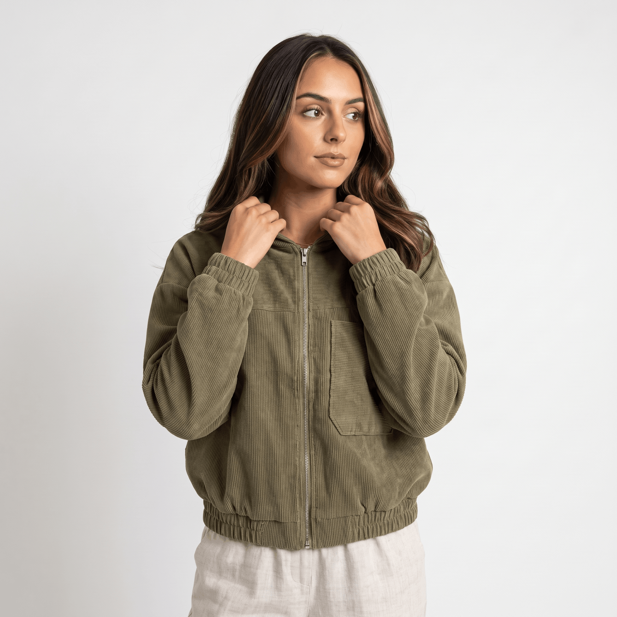 Olive green corduroy zip-up hoodie with a textured ribbed surface, elasticated cuffs, and a relaxed, roomy fit.
