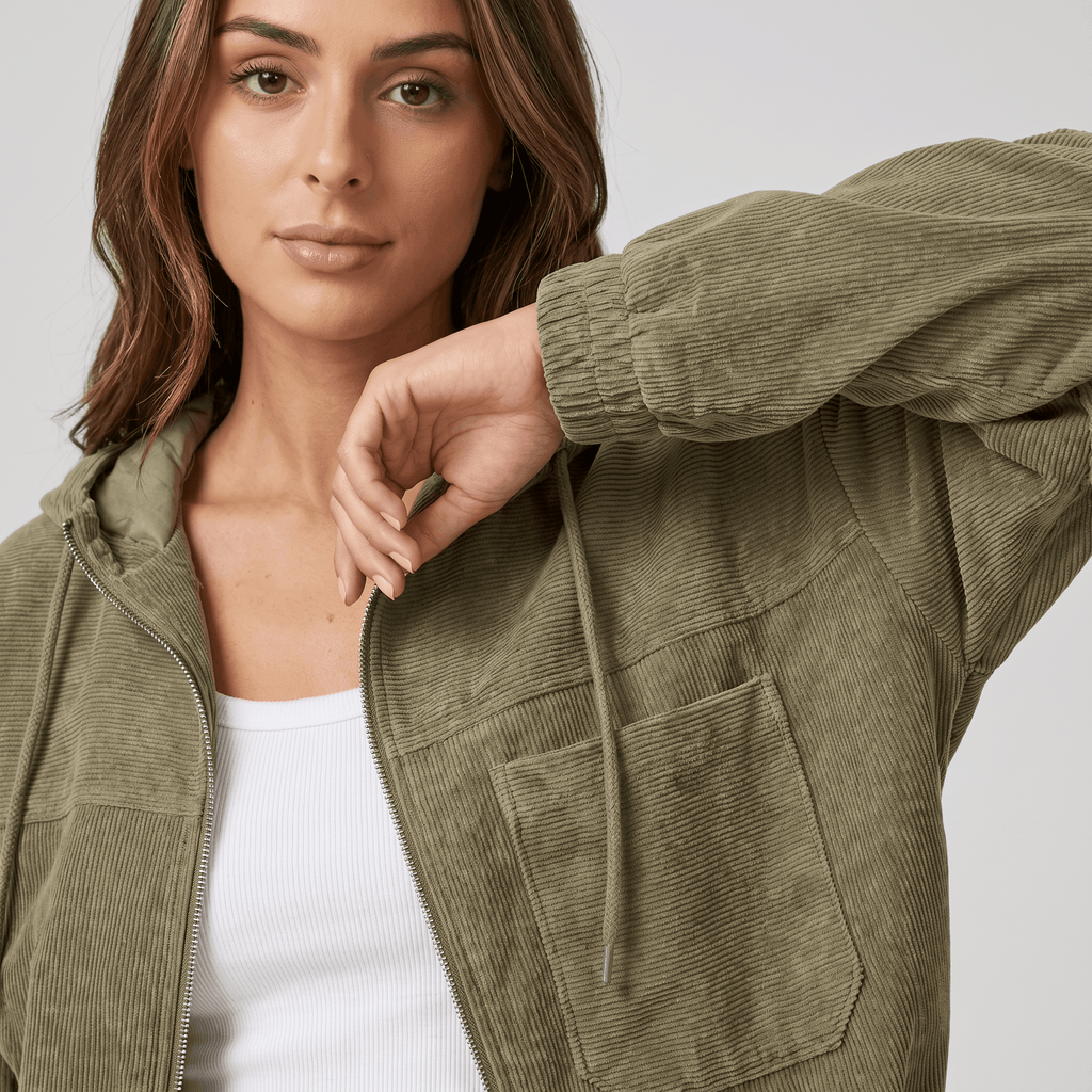 Olive green corduroy zip-up hoodie with a drawstring hood, elasticated cuffs, and a relaxed, textured fit.