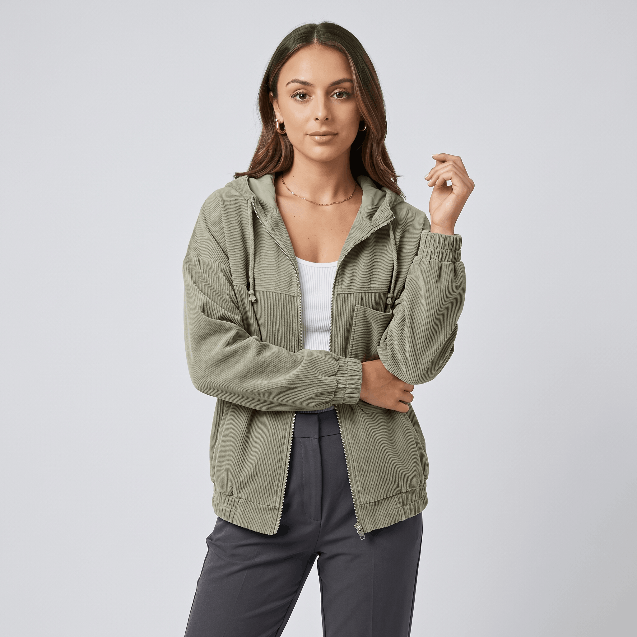 Sage green corduroy zip-up hoodie with a drawstring hood, elasticated cuffs, and a relaxed, layered fit.