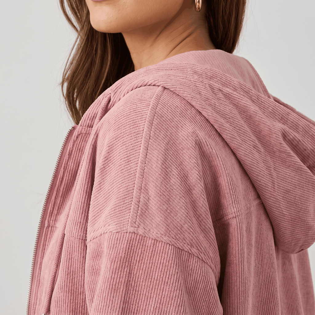 Dusty pink corduroy zip-up hoodie with a soft wale texture, featuring a relaxed fit and an adjustable drawstring hood.