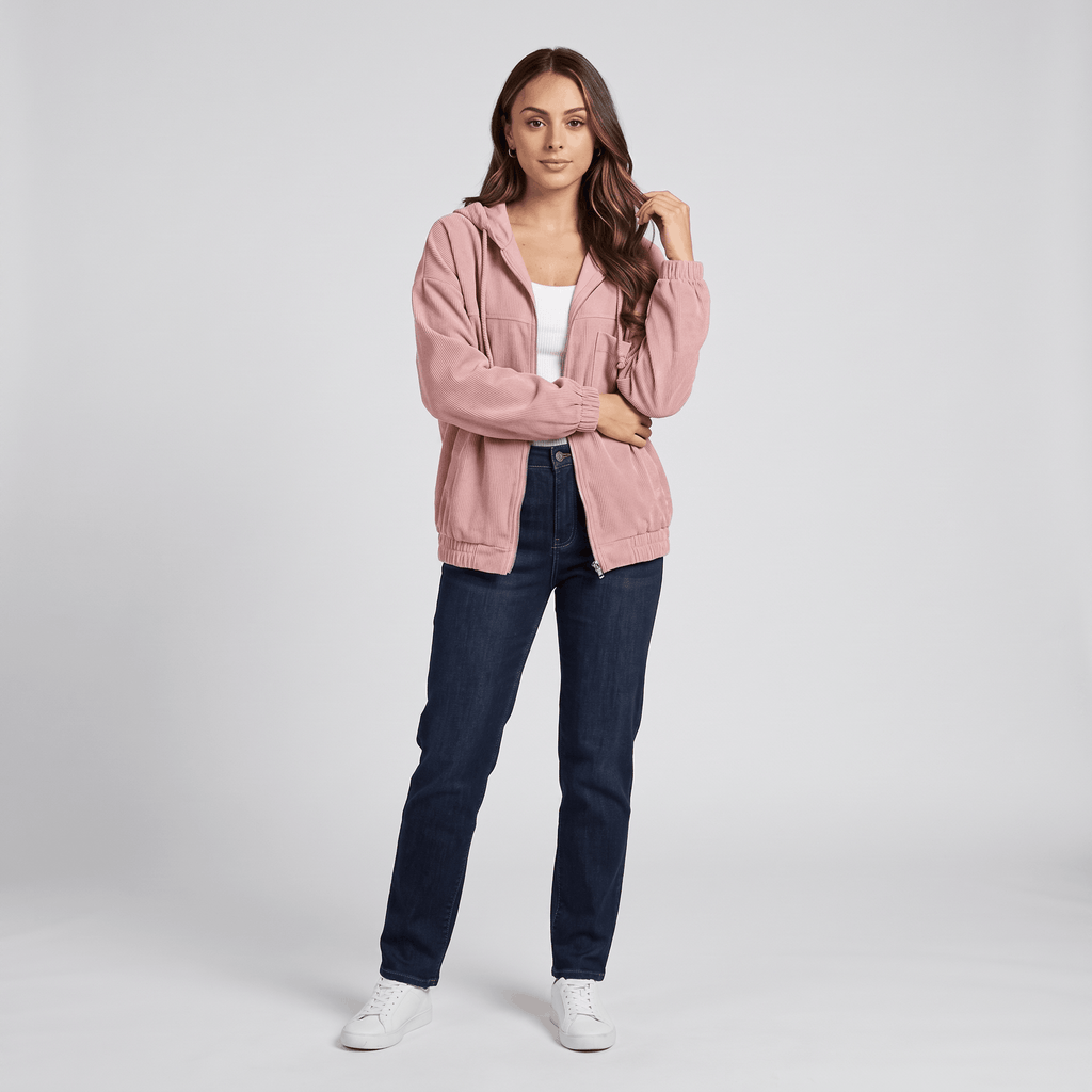 Dusty pink corduroy zip-up hoodie with a drawstring hood, elasticated cuffs, and a relaxed fit worn over a white top.