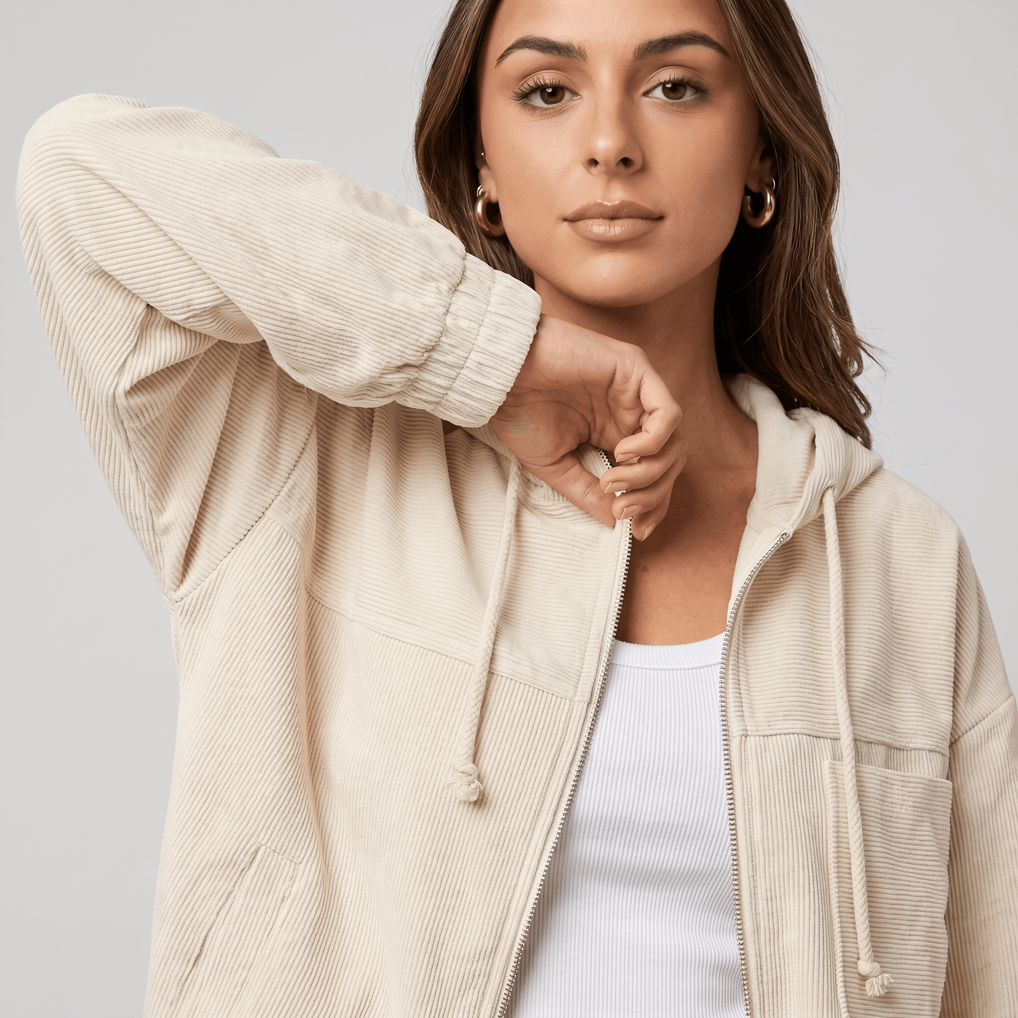 Cream corduroy zip-up hoodie with a drawstring hood, silver hardware, and elasticated cuffs in a relaxed layering fit.