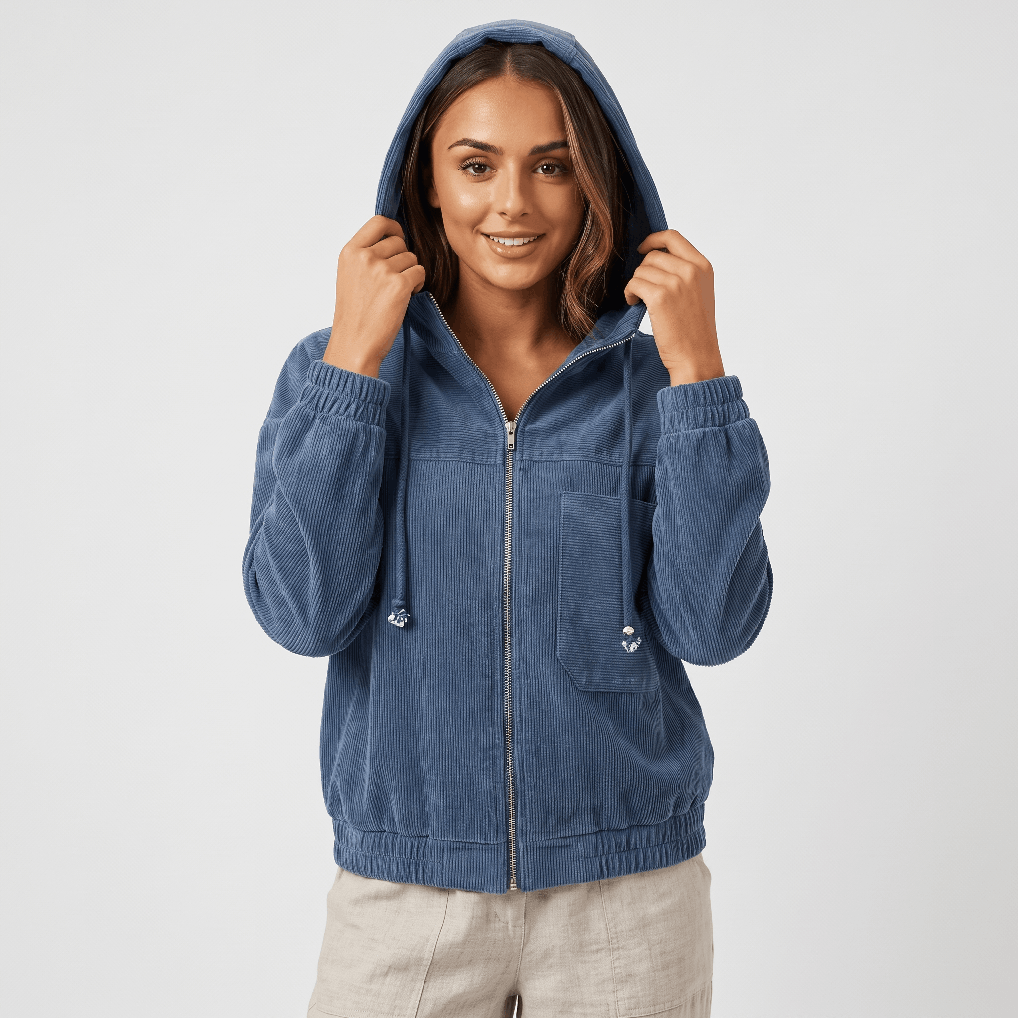 Washed blue corduroy zip-up hoodie with a drawstring hood, silver hardware, and elasticated cuffs in a relaxed fit.
