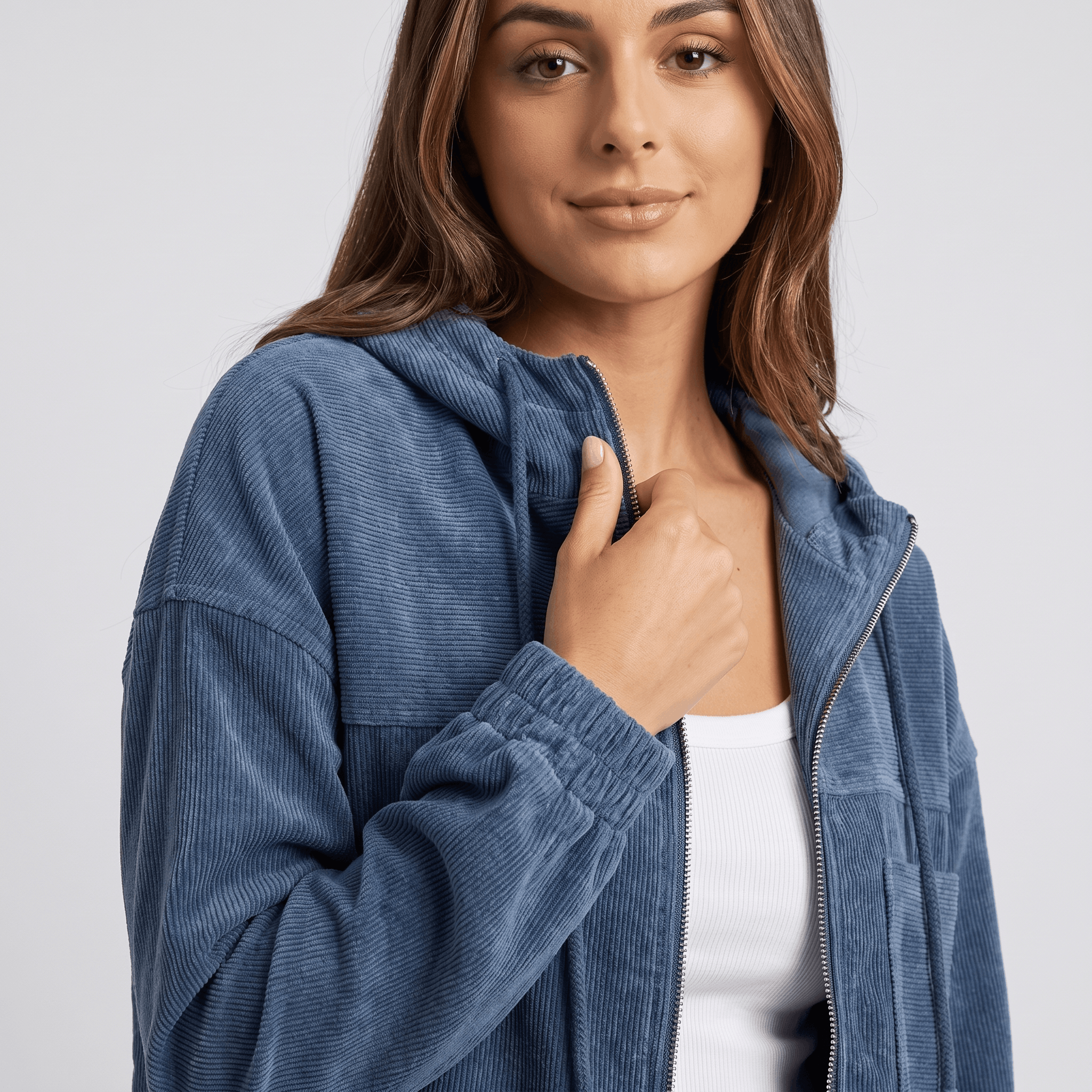 Washed blue corduroy zip-up hoodie with a textured ribbed surface, drawstring hood, and elasticated cuffs.