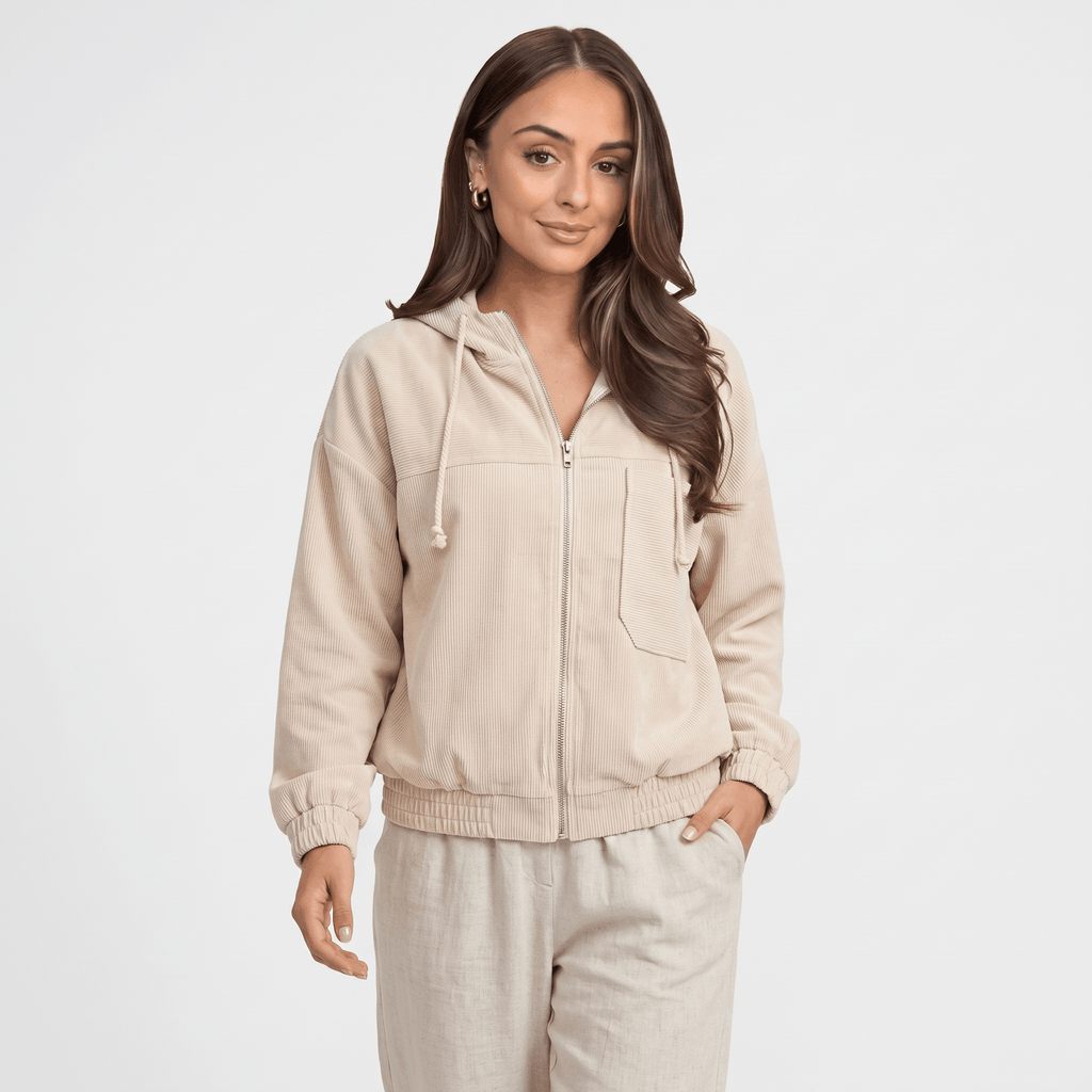 Beige corduroy zip-up hoodie with a drawstring hood, elasticated cuffs, and a relaxed fit on a model.