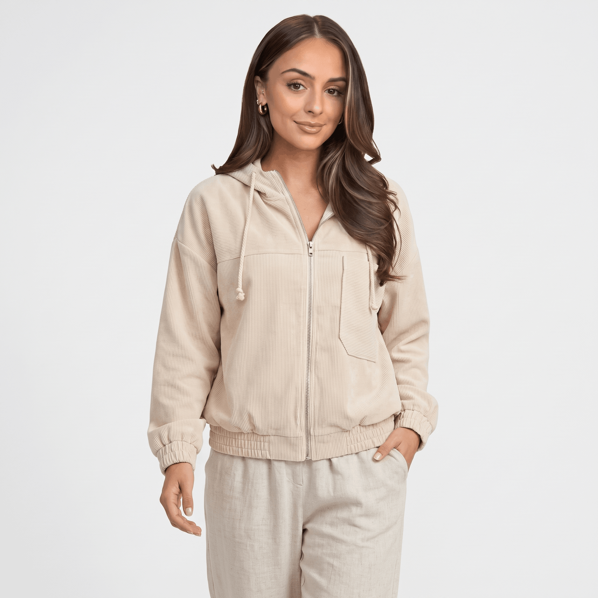 Beige corduroy zip-up hoodie with a drawstring hood, elasticated cuffs, and a relaxed fit on a model.