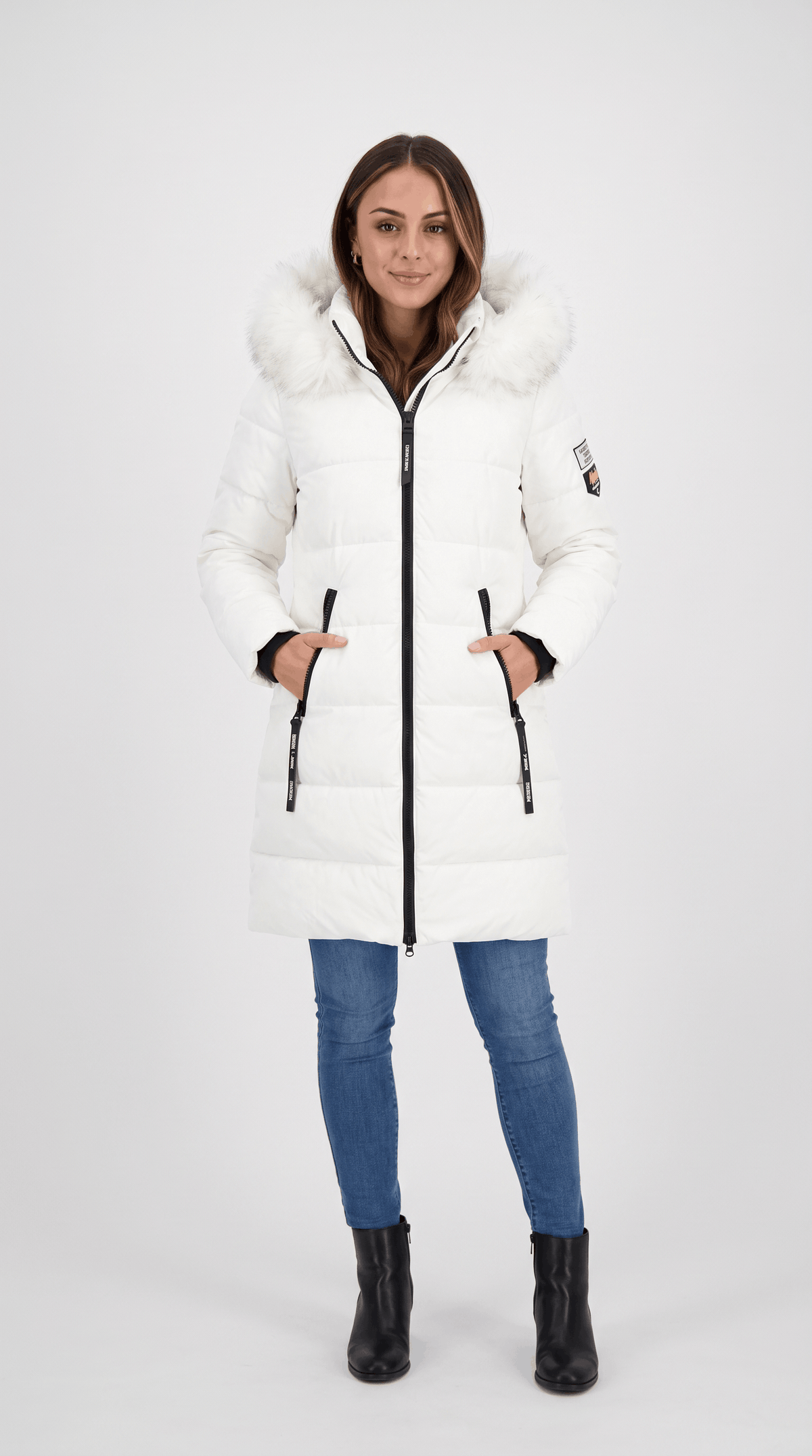 A woman wearing a white long insulated parka jacket with a hood and full-zip front