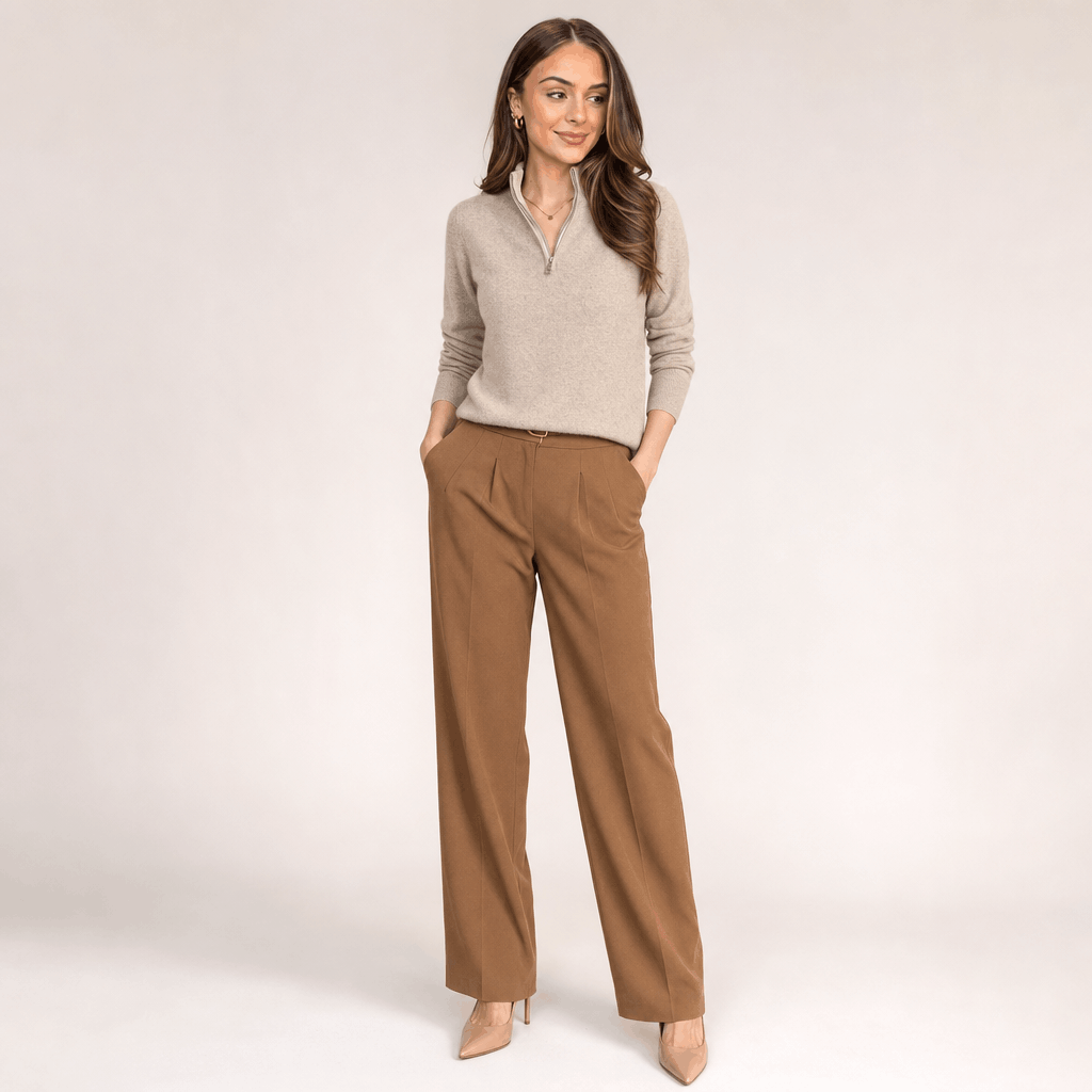 Full-body view of the woman wearing the taupe half-zip sweater with brown pants.