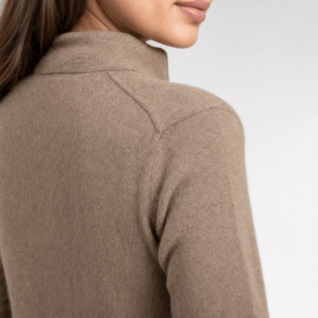 Back close-up showing the raised collar and ribbed knit texture of the taupe sweater.