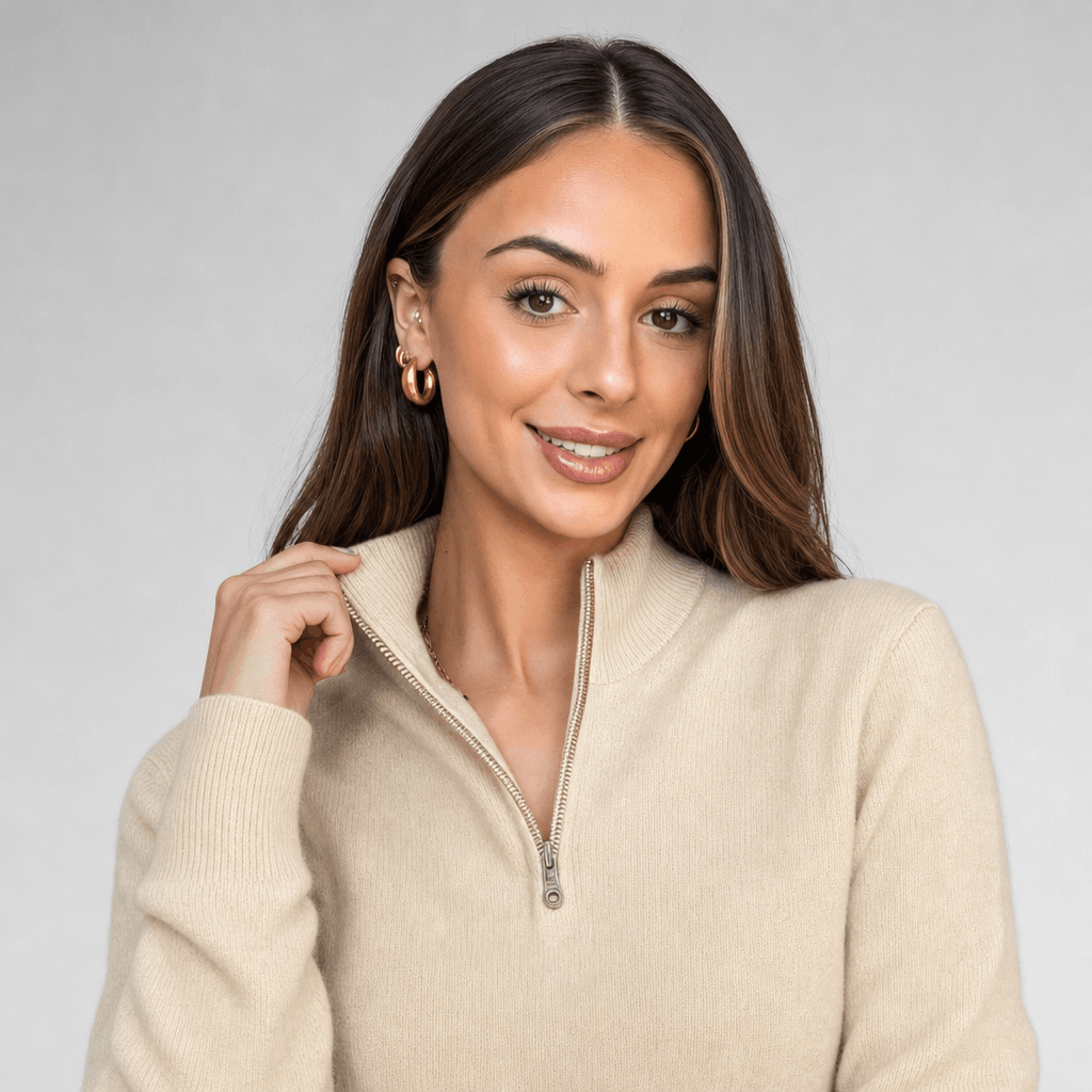 Close-up of the woman modeling the cream ribbed half-zip sweater.