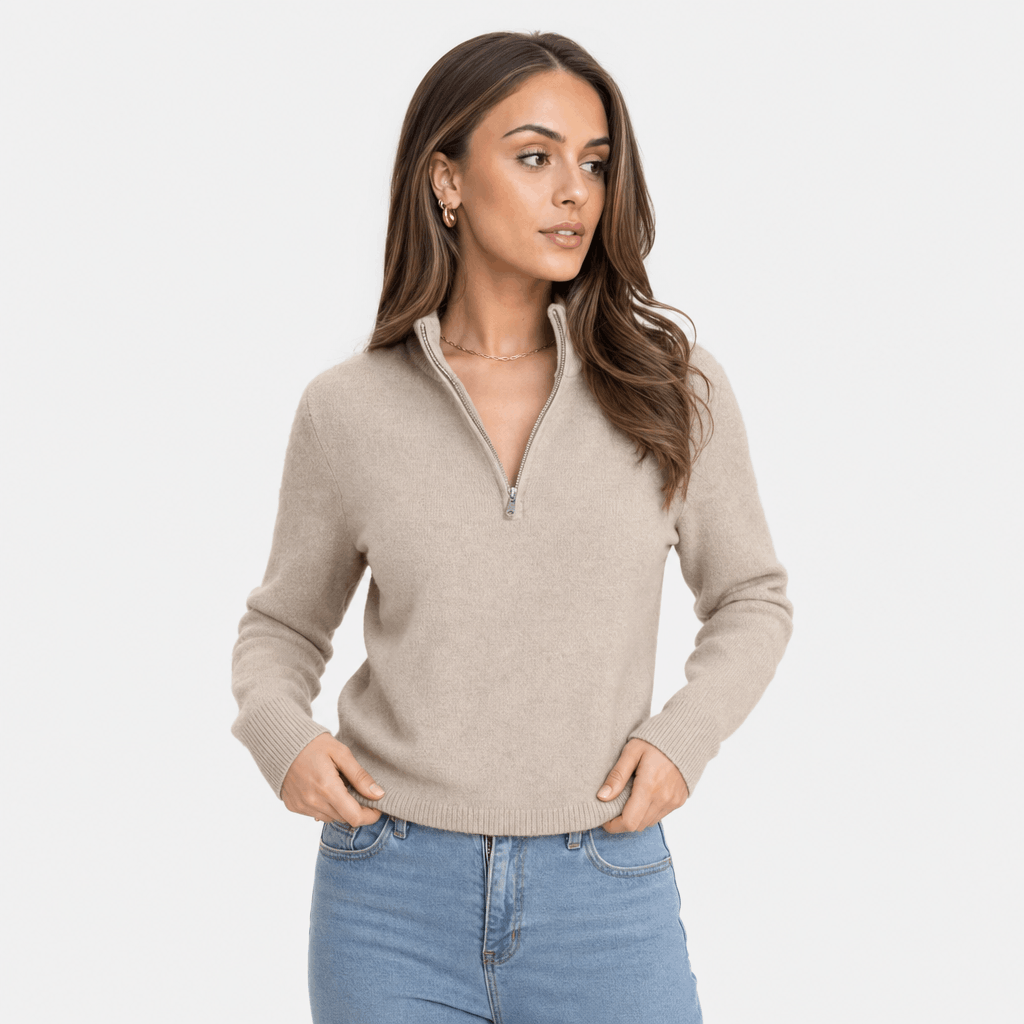 Woman wearing a taupe ribbed half-zip sweater, shown in a relaxed standing pose.