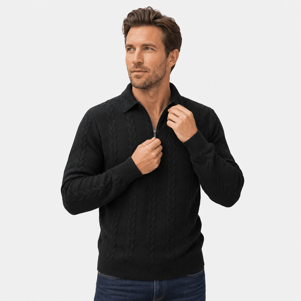 Close-up of the man wearing the black quarter-zip sweater, highlighting the raised collar and cable-knit texture.