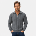 Grey cable-knit quarter-zip sweater with a point collar, ribbed cuffs, and textured jacquard pattern on a model.
