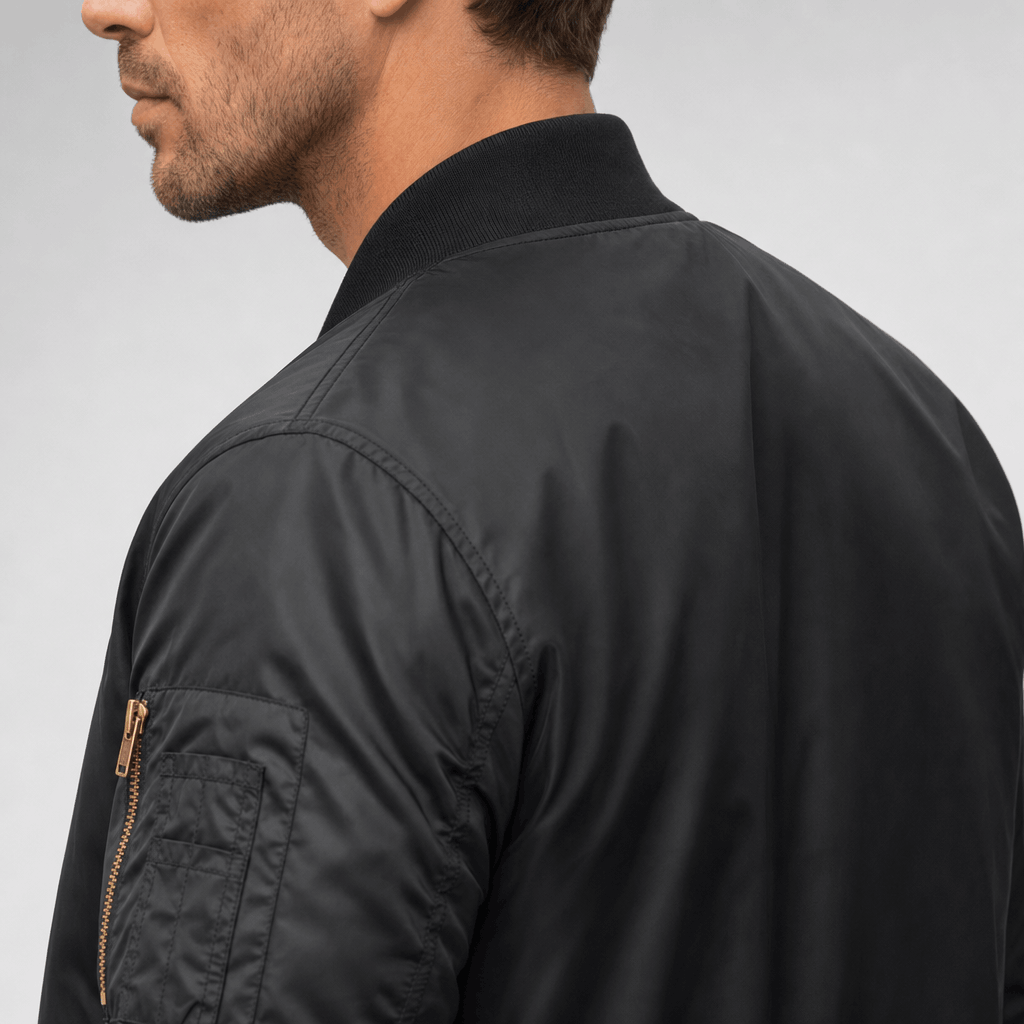 Side and back view of the black bomber jacket, showing the ribbed texture on the sleeve and shoulder.