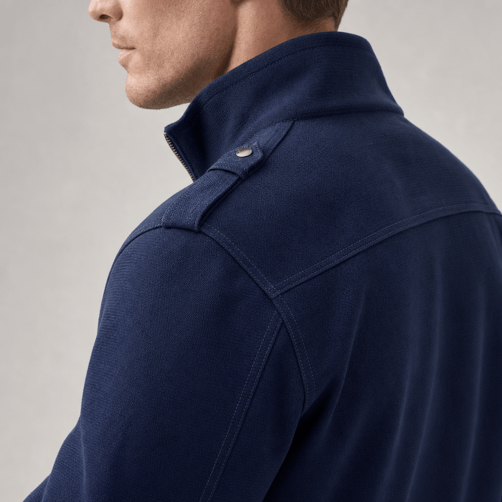 Close-up side and back view of the navy blue jacket, showing the stand collar and shoulder seams.