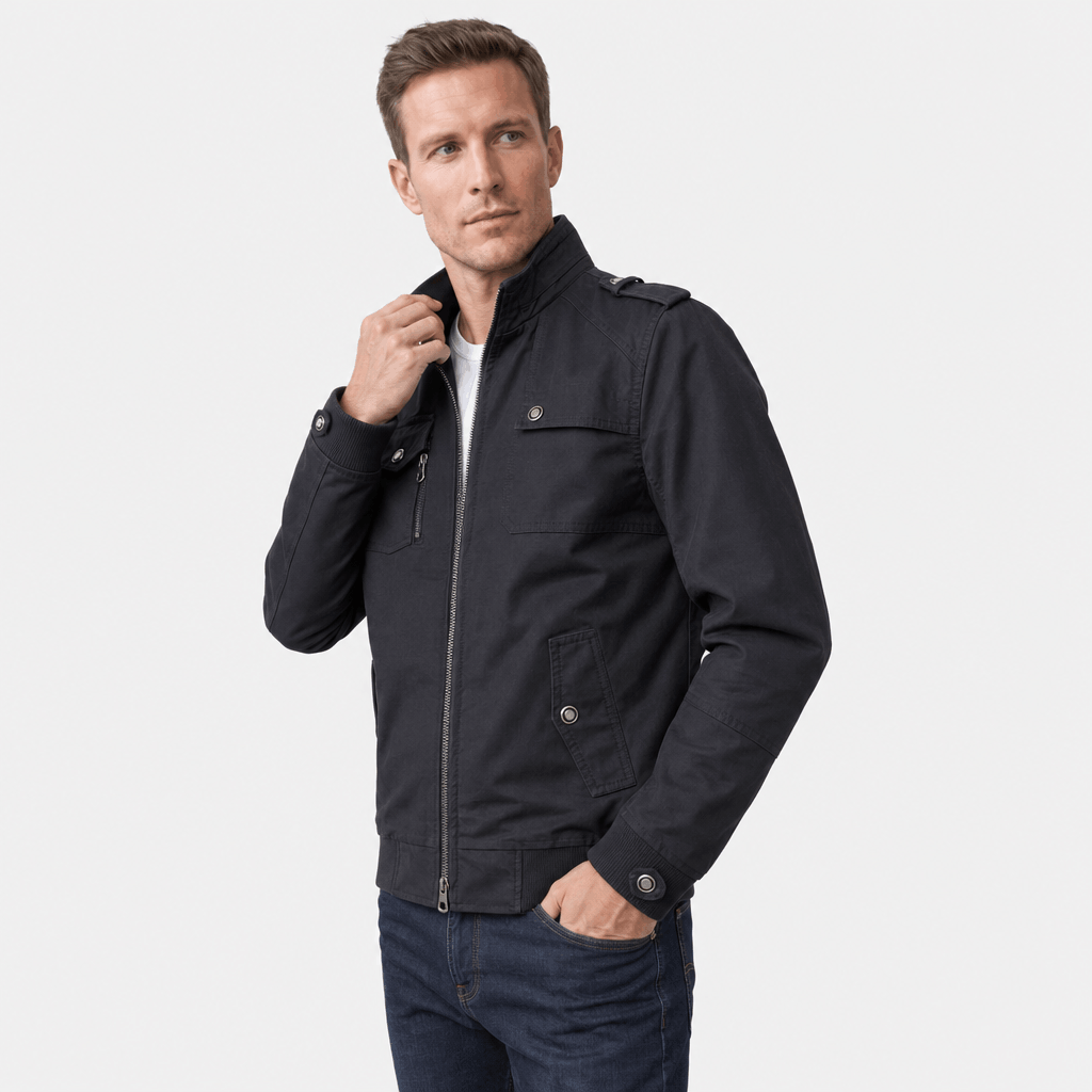 Male model wearing a black utility-style zip-up jacket with dark trousers.
