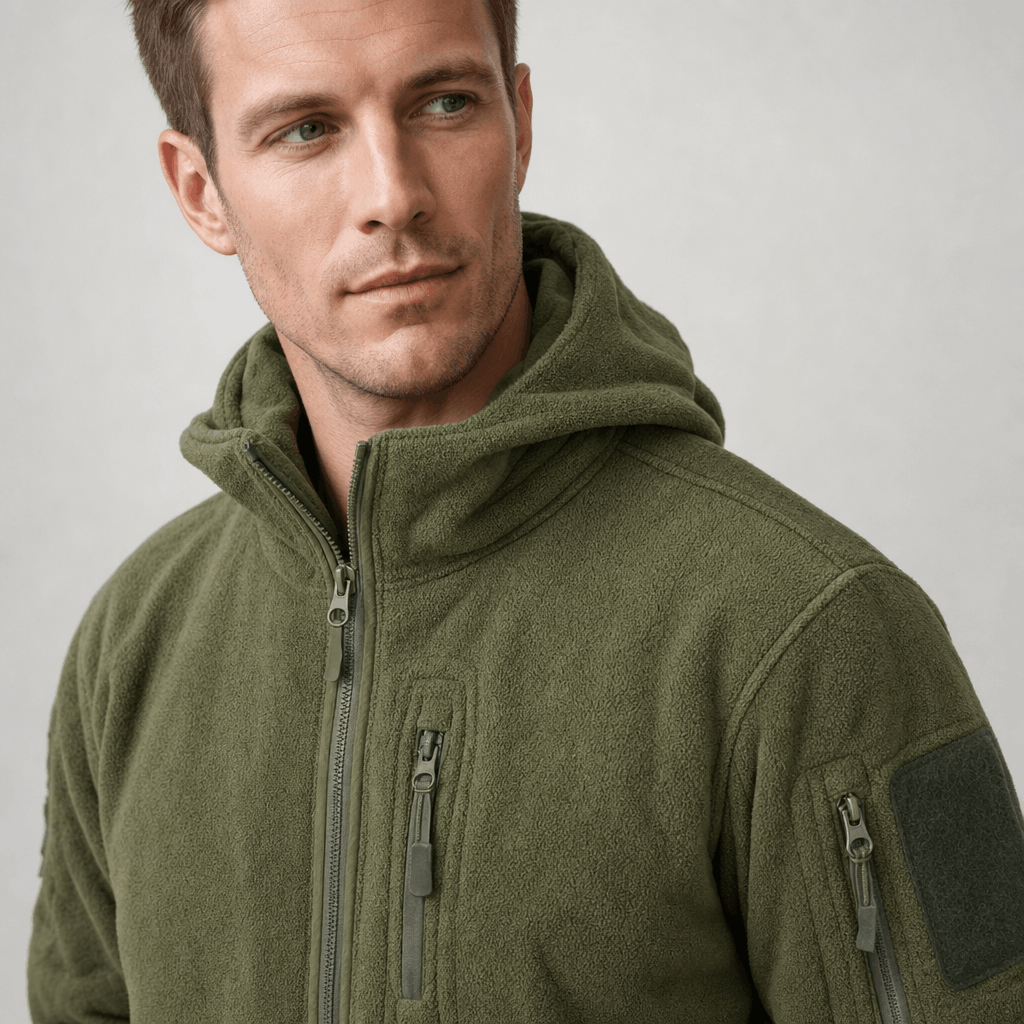 Detailed front view of the olive green jacket, showing the hood, zipper, and chest pocket.
