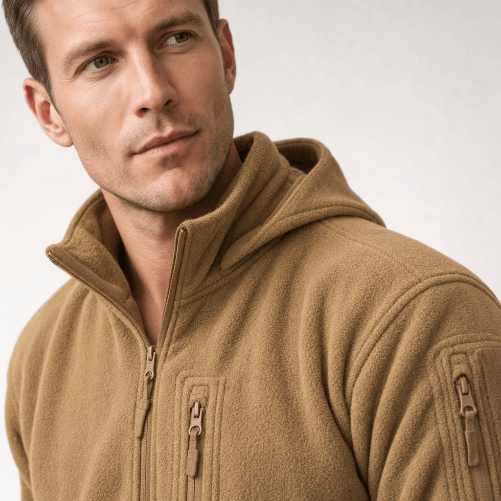 Detailed view of the tan jacket, highlighting the hood, zipper, and sleeve pocket.
