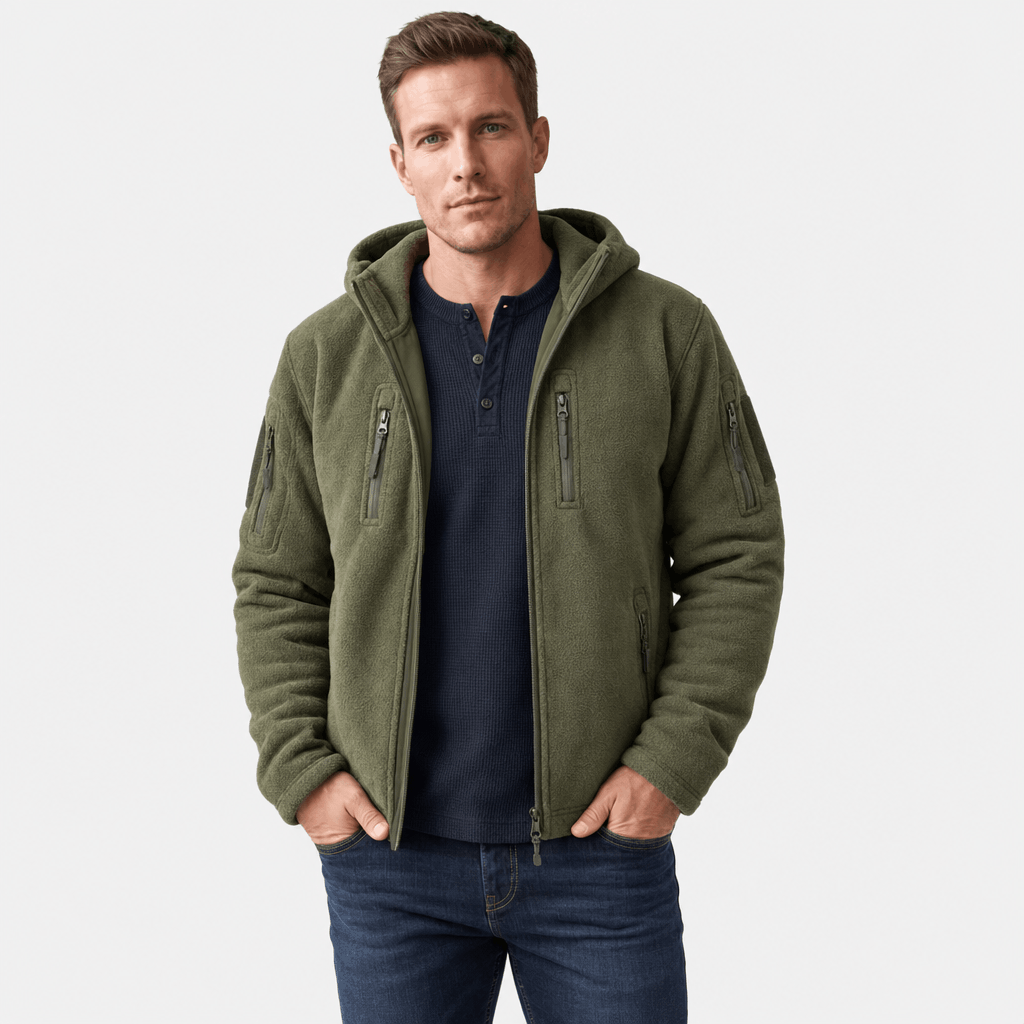 Male model wearing an olive green hooded zip-up jacket with zippered chest and sleeve pockets.