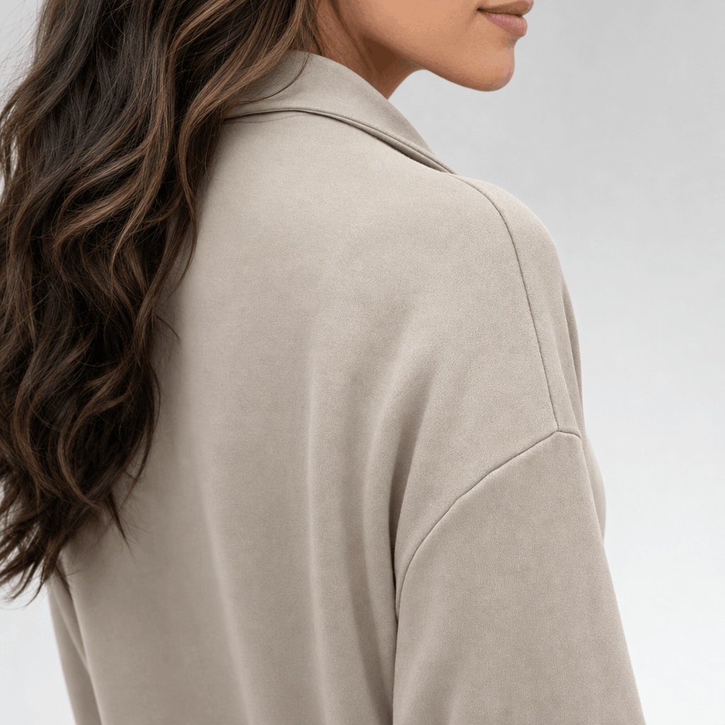 Back and side close-up of the sweater, showing the relaxed shoulder fit and high collar.