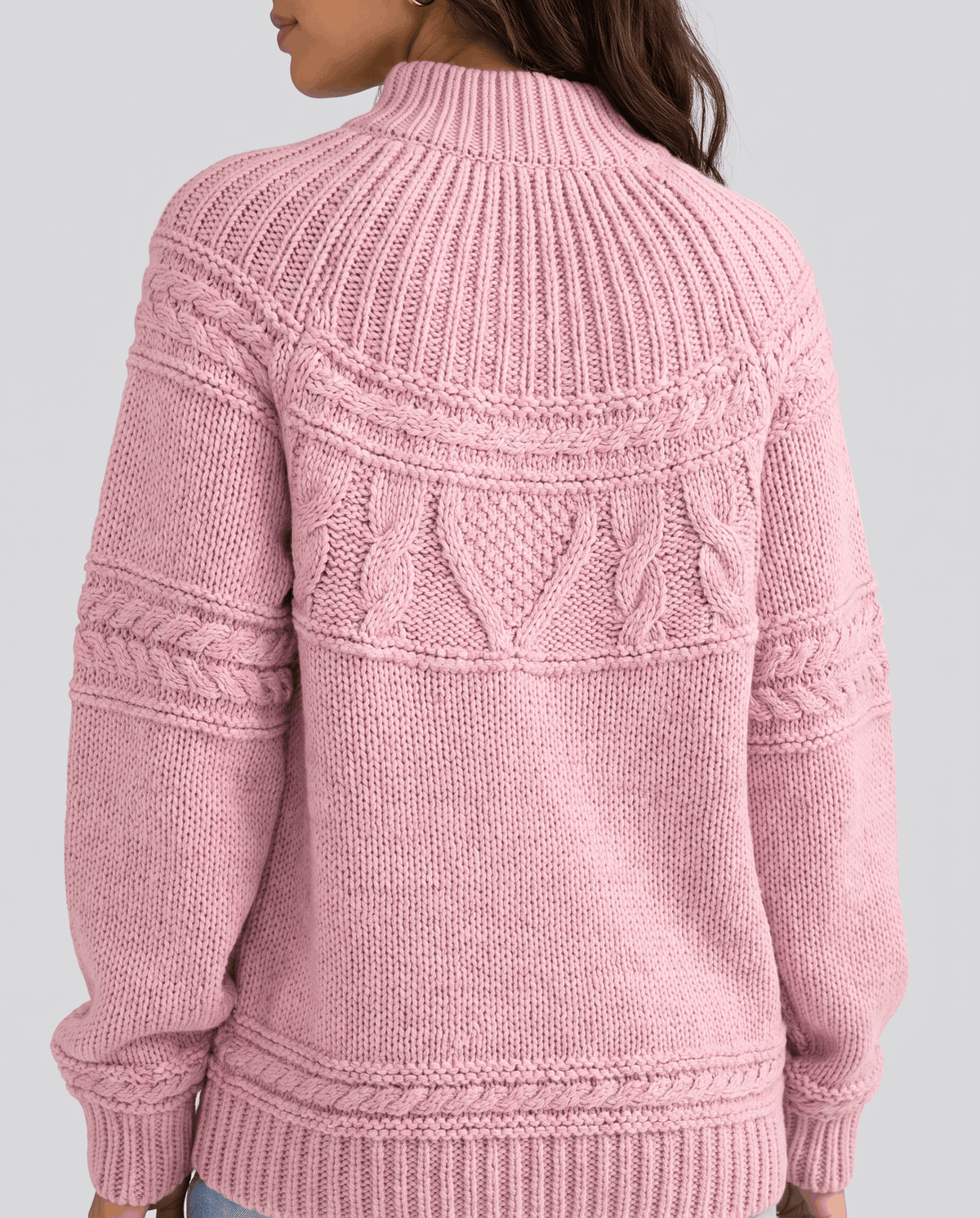 Pink Merino Wool Cable Knit Sweater worn by a female model from the back, showcasing the textured cable knit pattern, relaxed fit, high neckline, and ribbed hem.