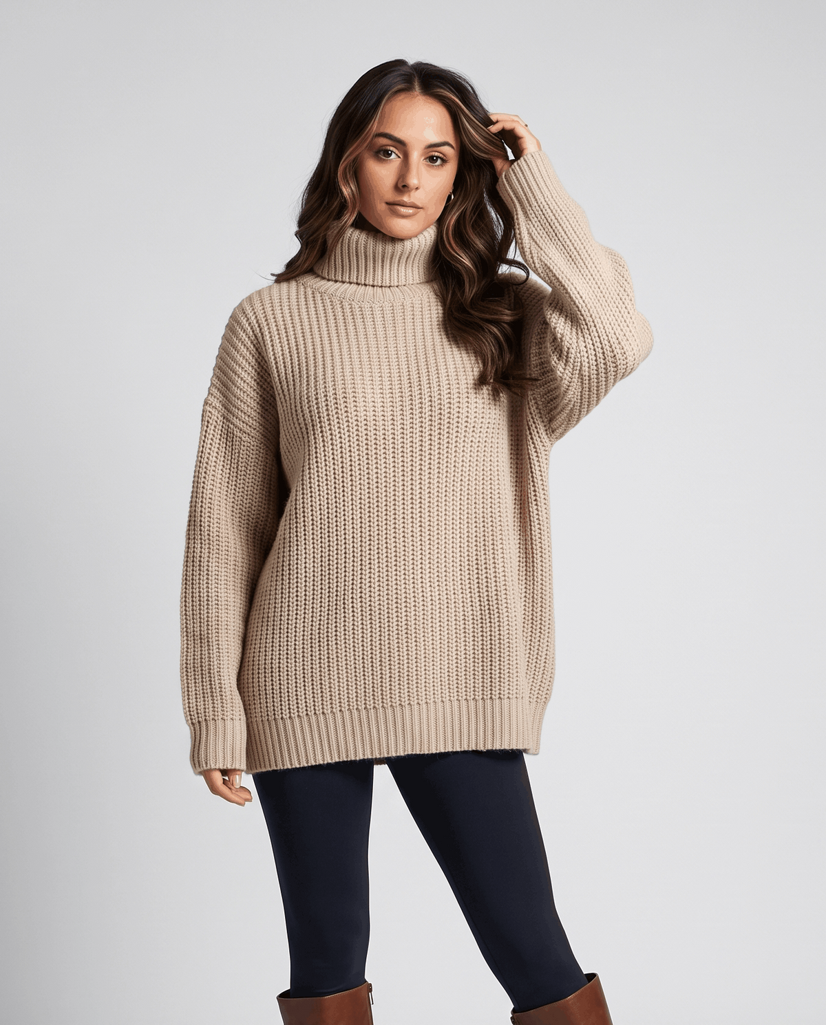 Dark Beige Merino Wool Turtleneck Sweater worn by a female model, featuring an oversized fit, high turtleneck collar, long sleeves, and ribbed cuffs.