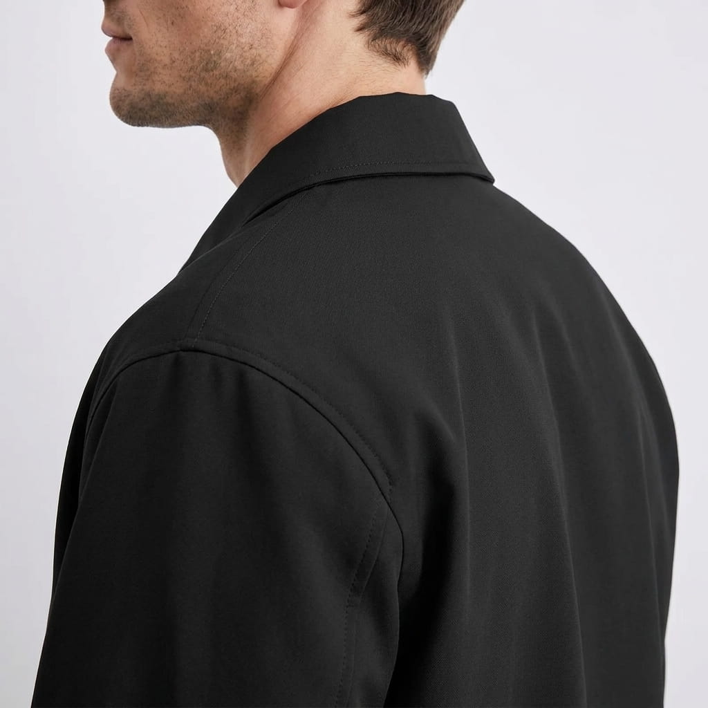 Close-up back view showing the collar and shoulder of the black jacket.