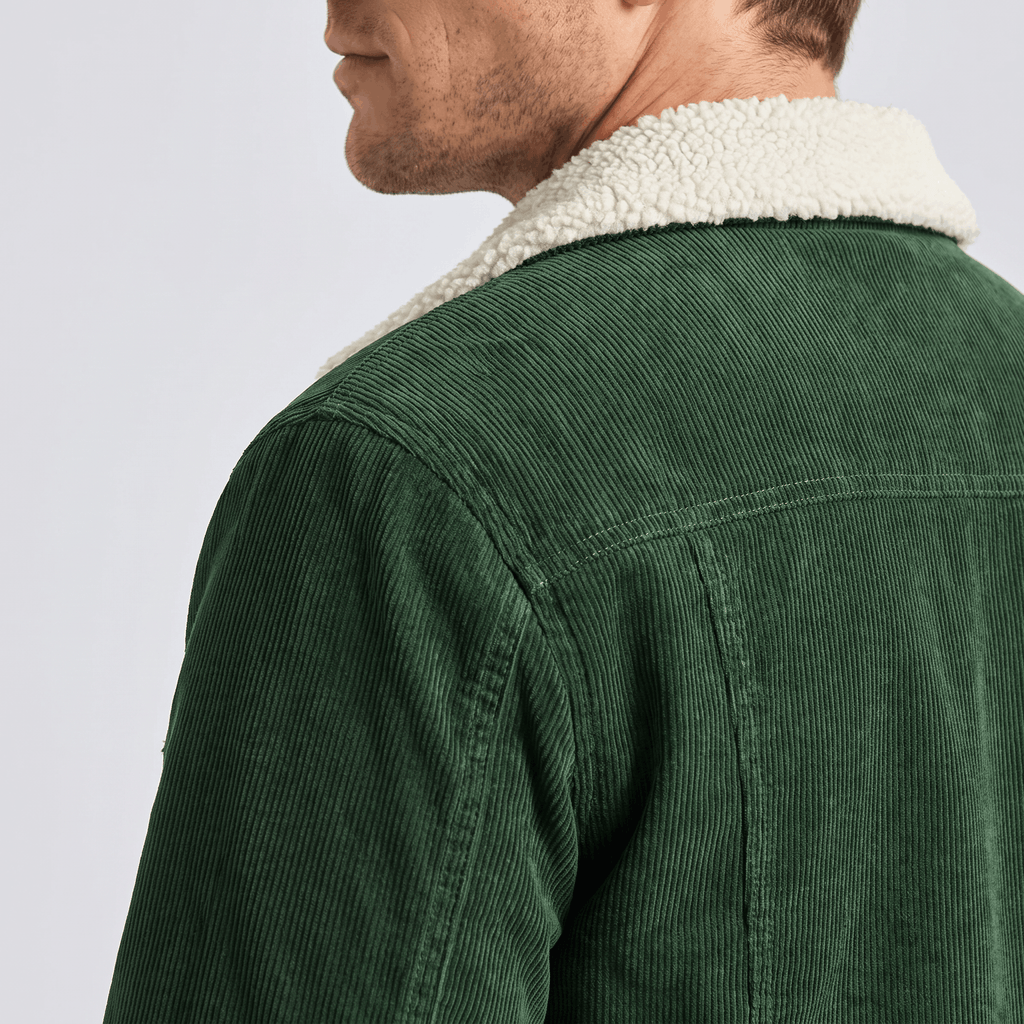 Dark green cotton corduroy jacket featuring a thick white sherpa turn-down collar and structured back yoke.